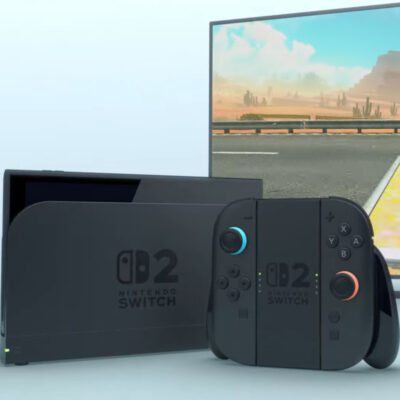 Die Nintendo Switch 2 in der Docking Station mit den Joy-Cons als externer Controller zusammengefügt. Auf dem Bildschirm im Hintergrund läuft das Spiel Mario Kart.